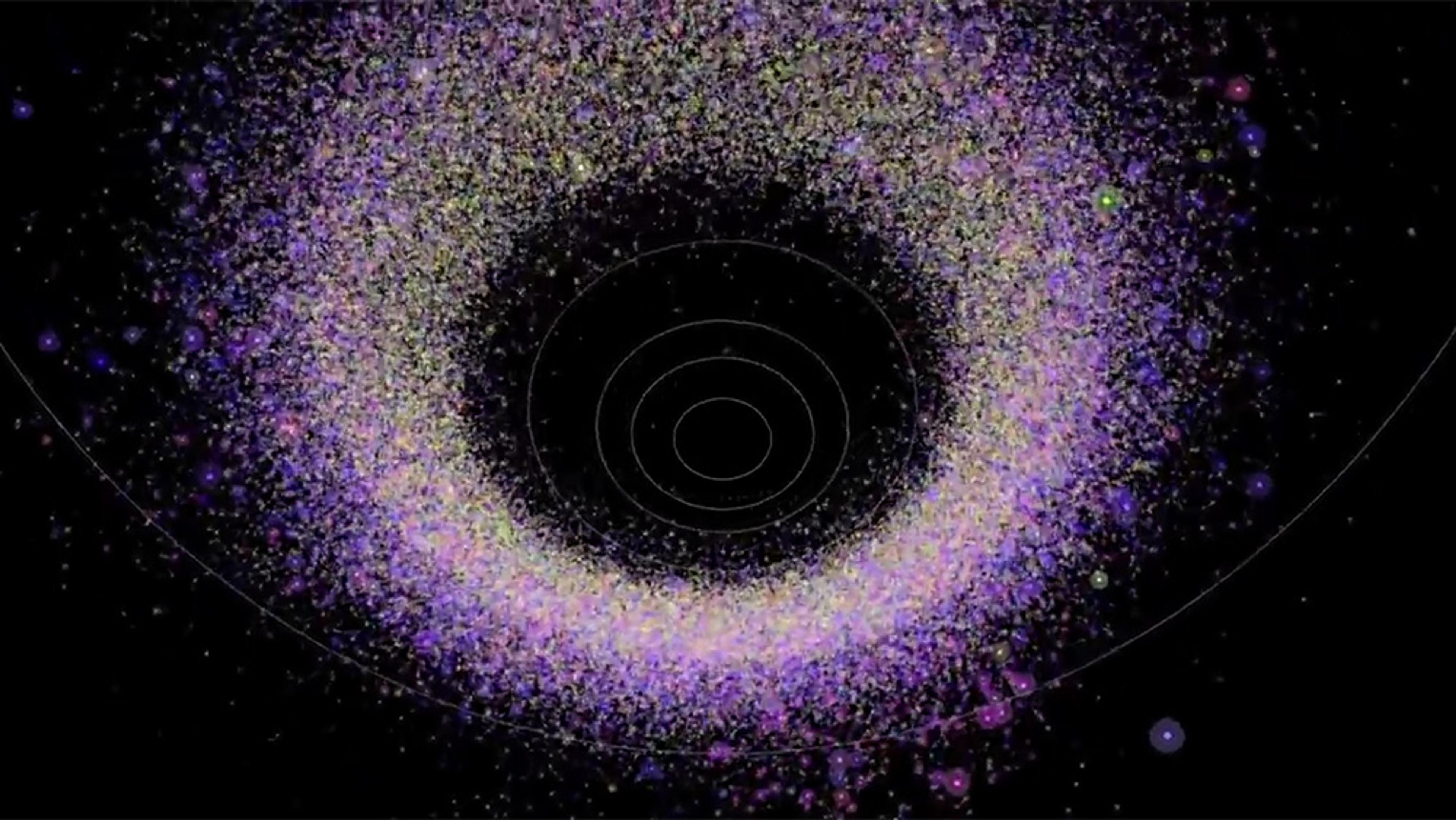 A digital illustration of a dense ring of colourful small dots forming a halo pattern with concentric circles at the centre on a black background.
