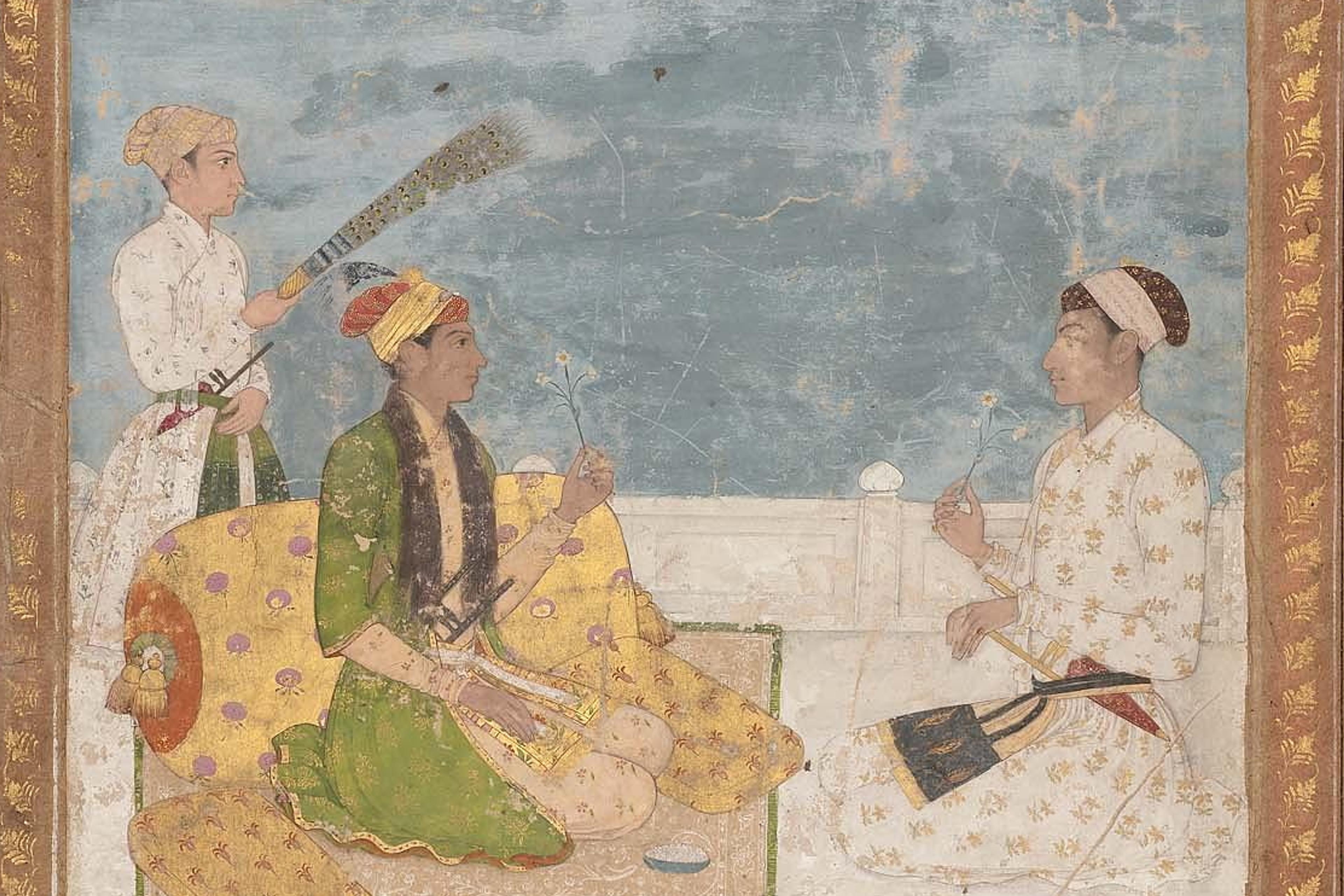 Indian miniature painting of three figures with flowers and a fan on a terrace, bordered with gold leaf.