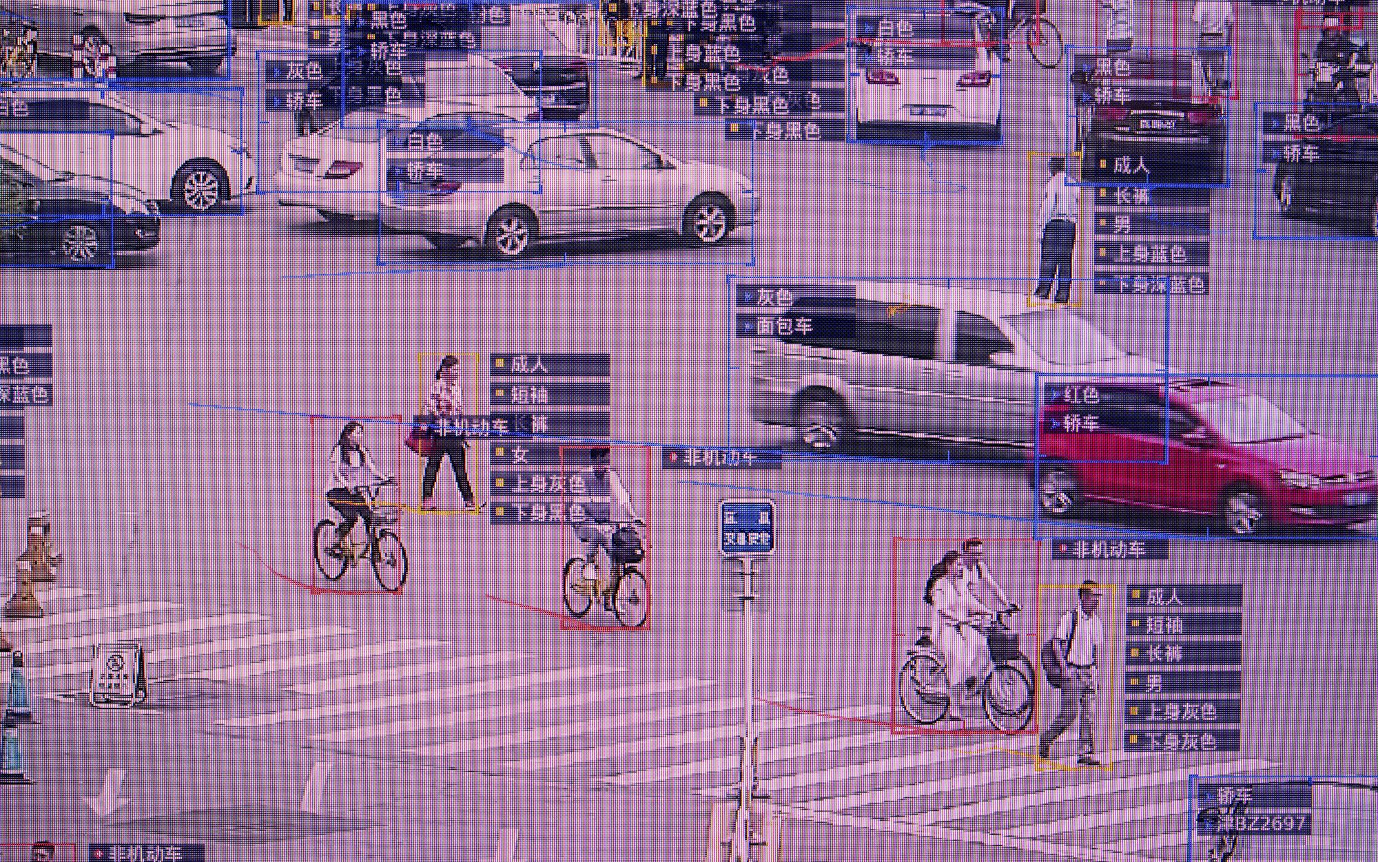 A city street with vehicles and cyclists, annotated with rectangles and labels in Chinese script for automated recognition.