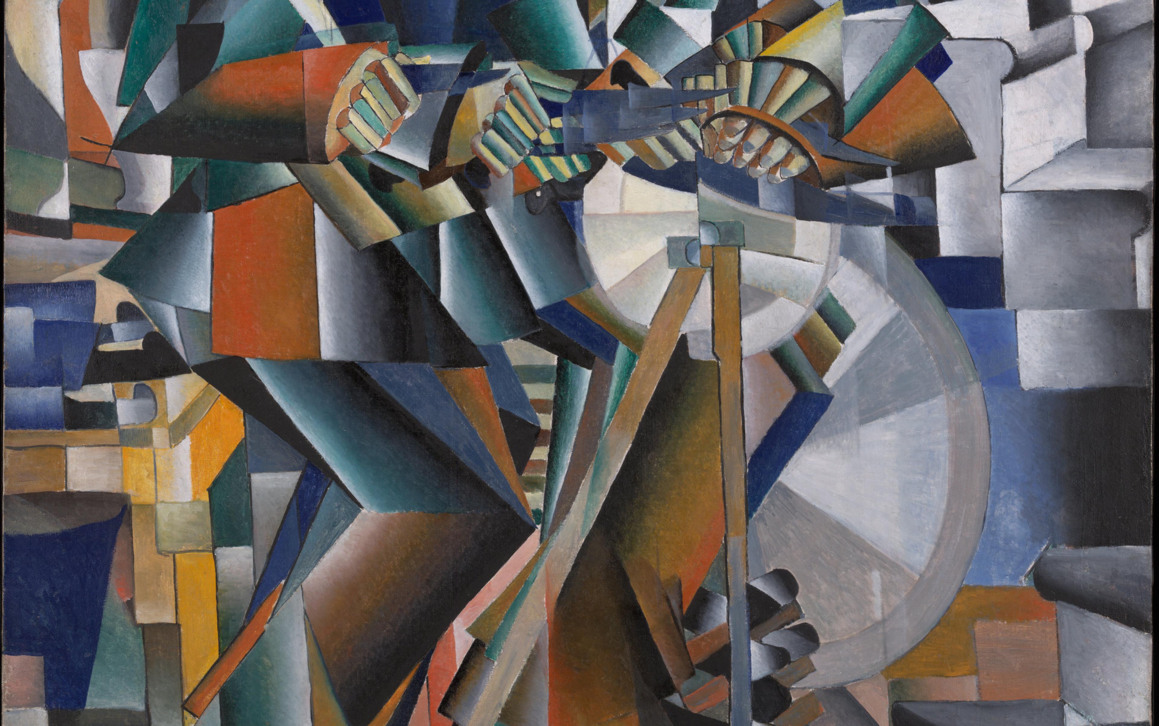 Cubist painting depicting a man playing a guitar, rendered with abstract geometric shapes in various colours including blue, orange, and green.
