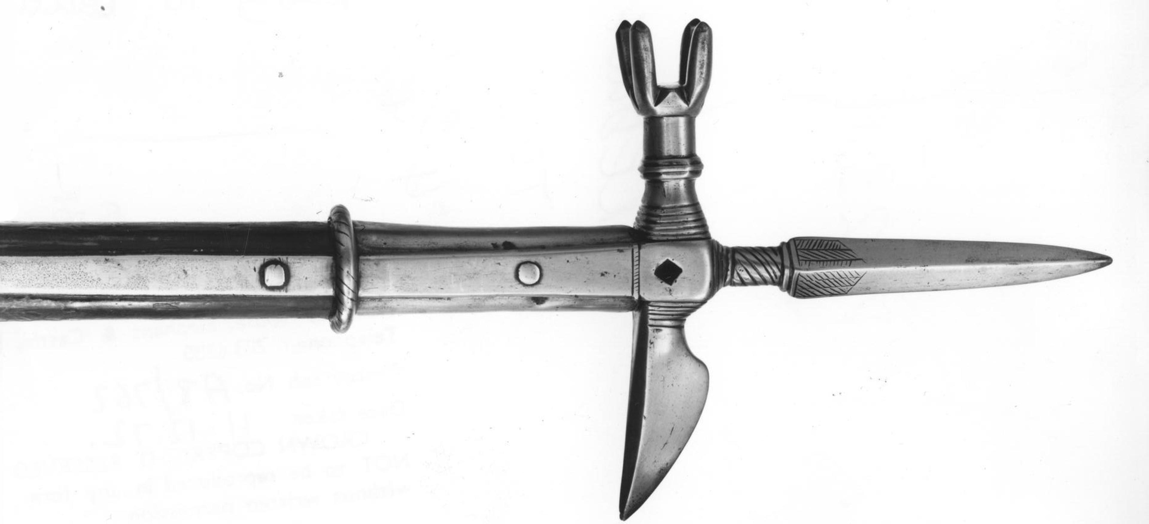 A metal pollaxe head with an axe blade and spike on a white background.