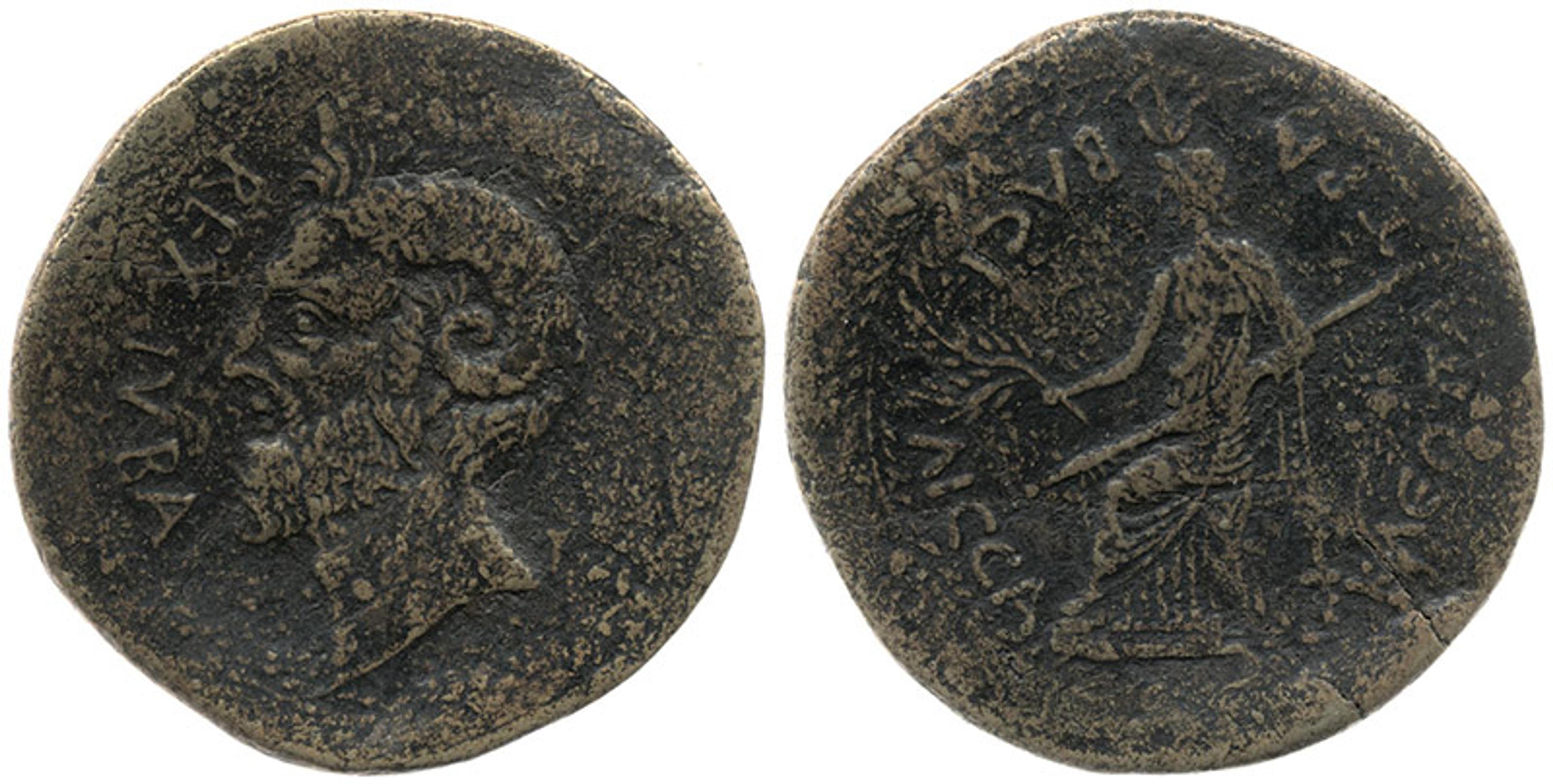 Photo of an ancient coin showing a bearded man in profile on one side and a standing figure holding a branch on the other.