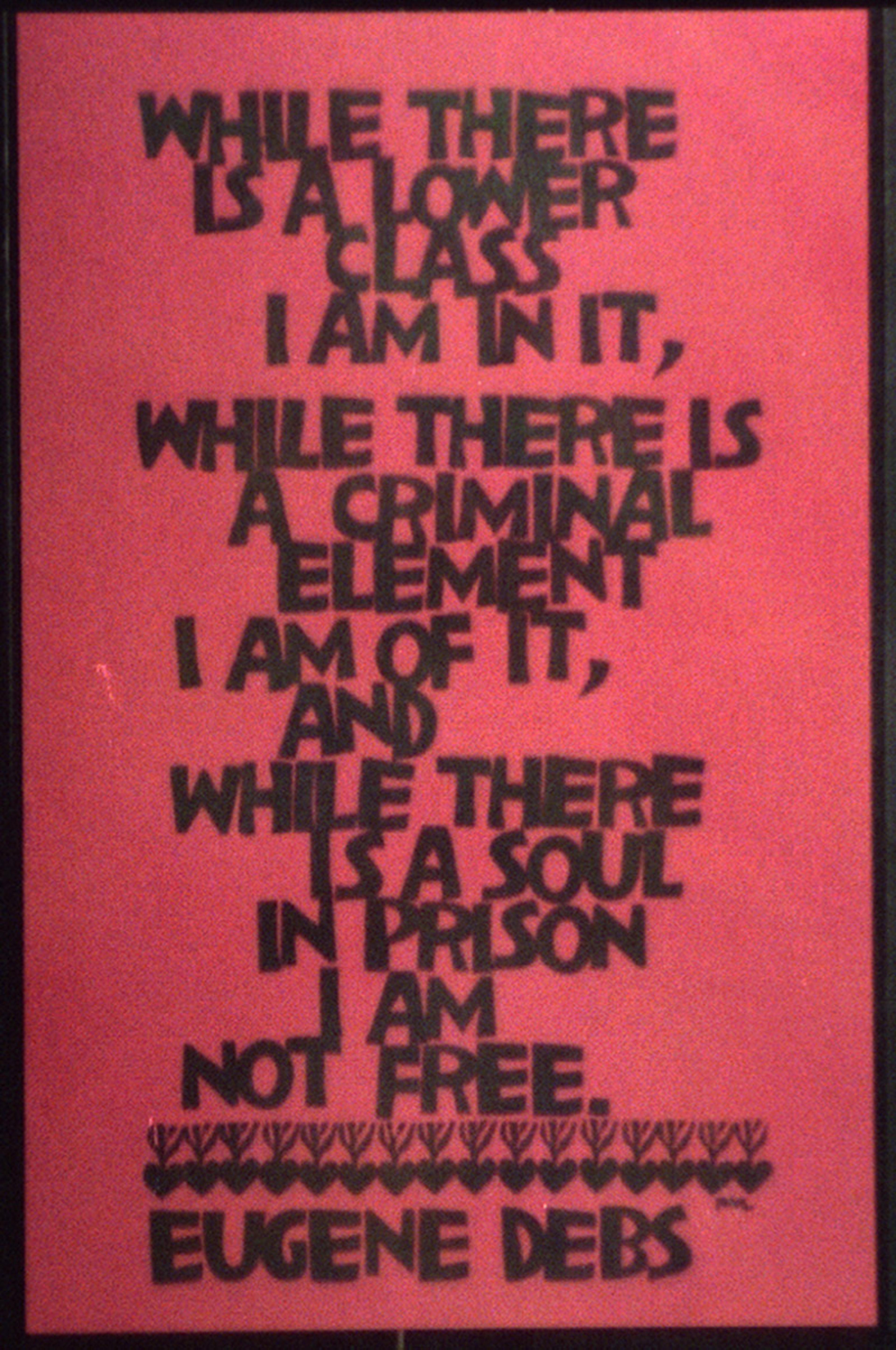 A red poster reading ‘Where there is a lower class, I am in it, while there is a criminal element I am of it, and while there is a soul in prison I am not free’ 
