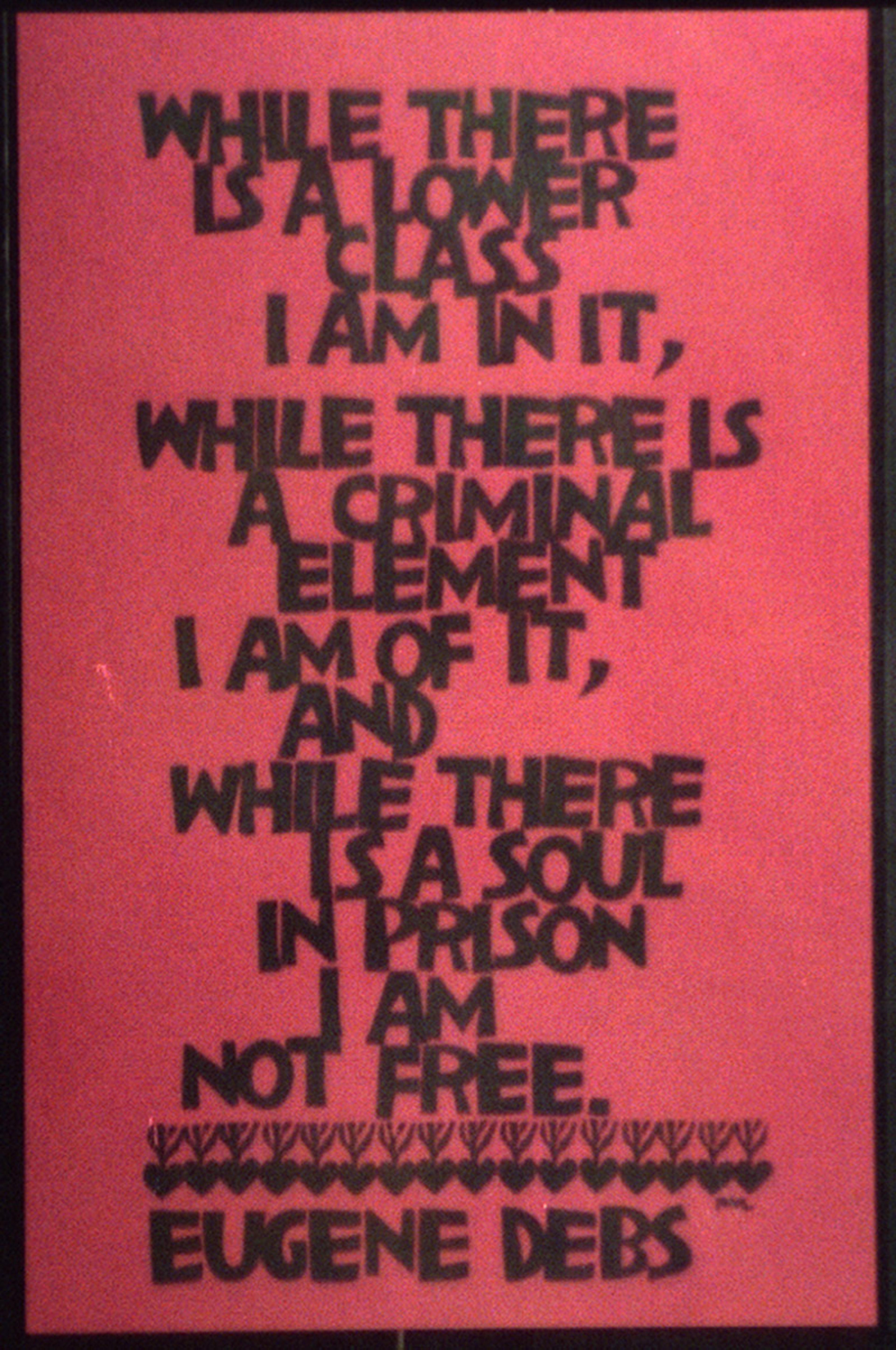 A red poster reading ‘Where there is a lower class, I am in it, while there is a criminal element I am of it, and while there is a soul in prison I am not free’