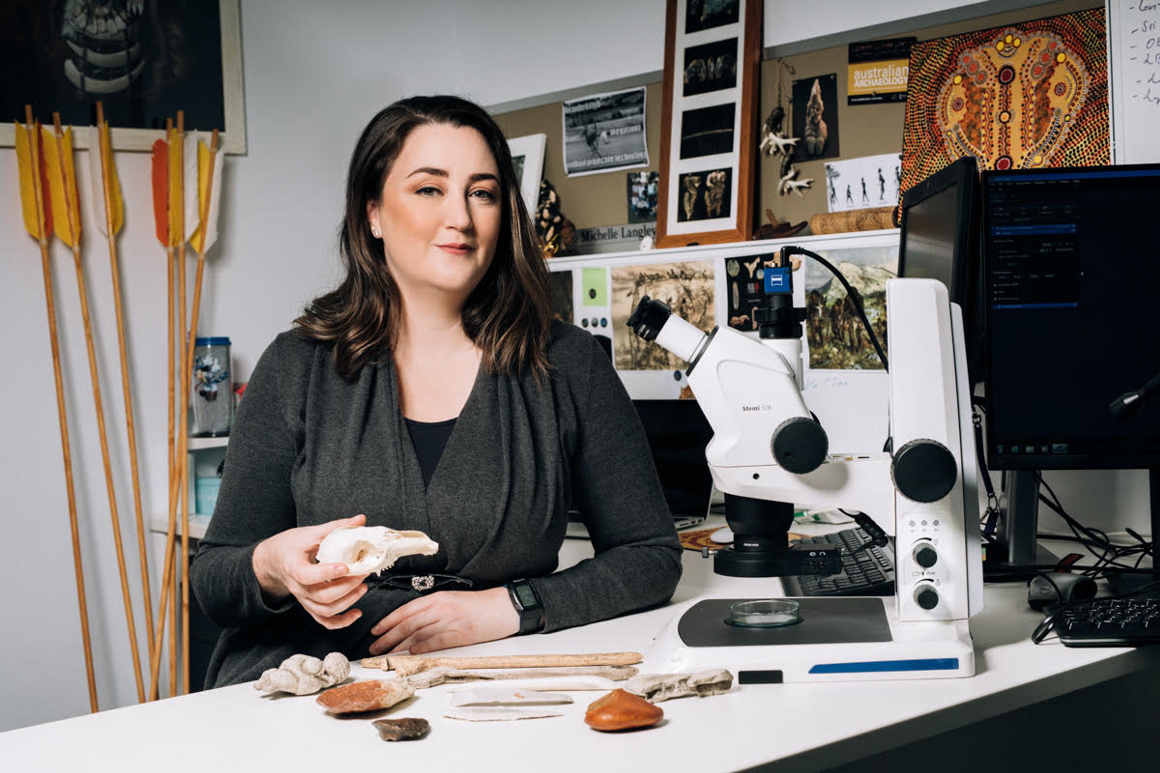 Archaeologist Michelle Langley holding a fossil