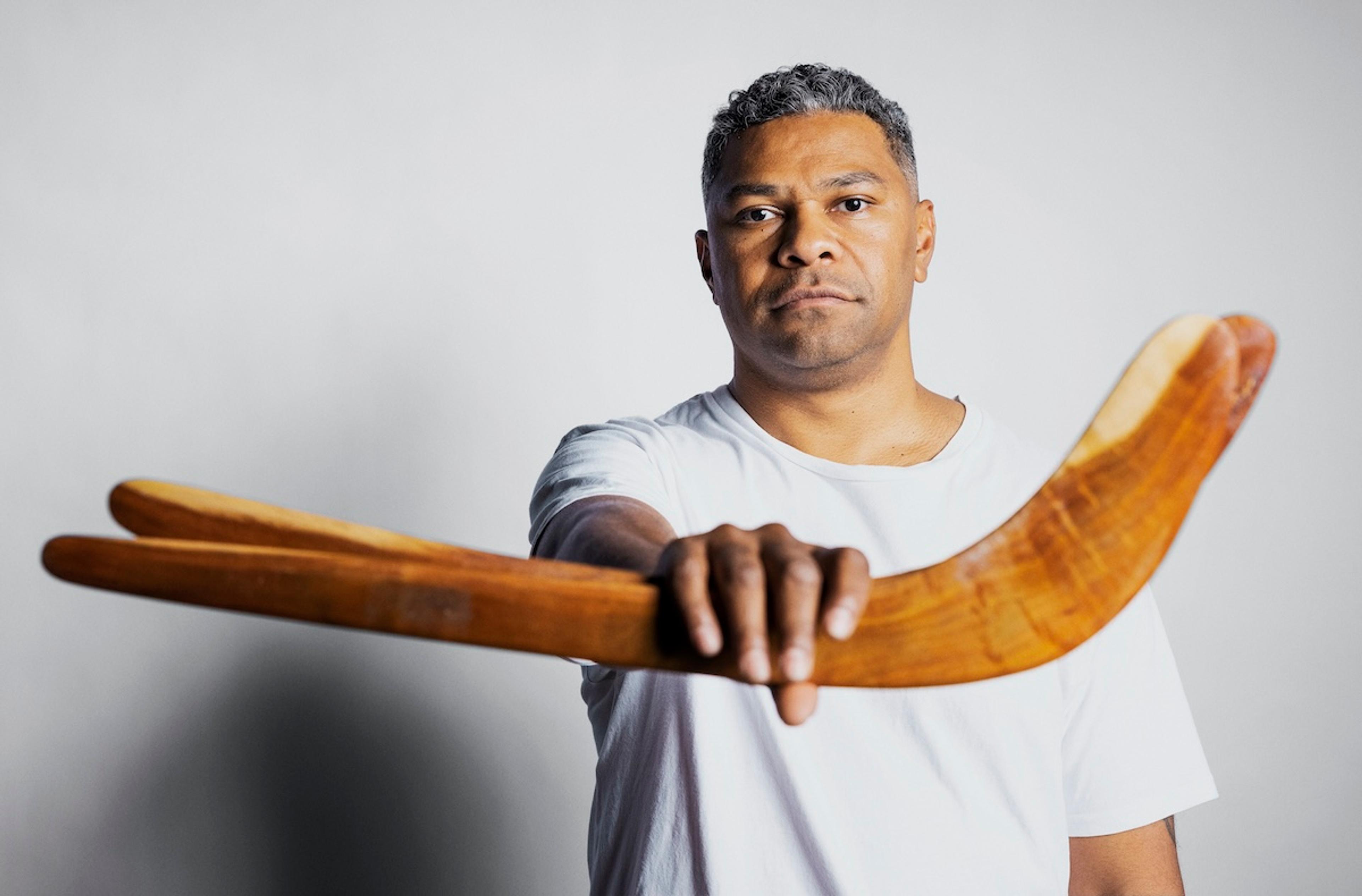 Fred Leone holding two boomerangs