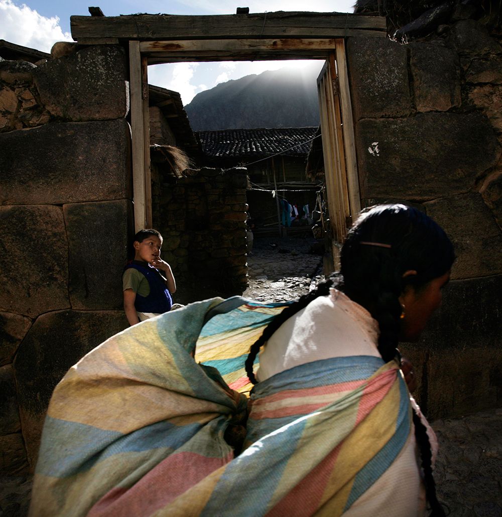 A woman walks through the town of Ollantaytambo. Photo by Karla Gachet/Panos.