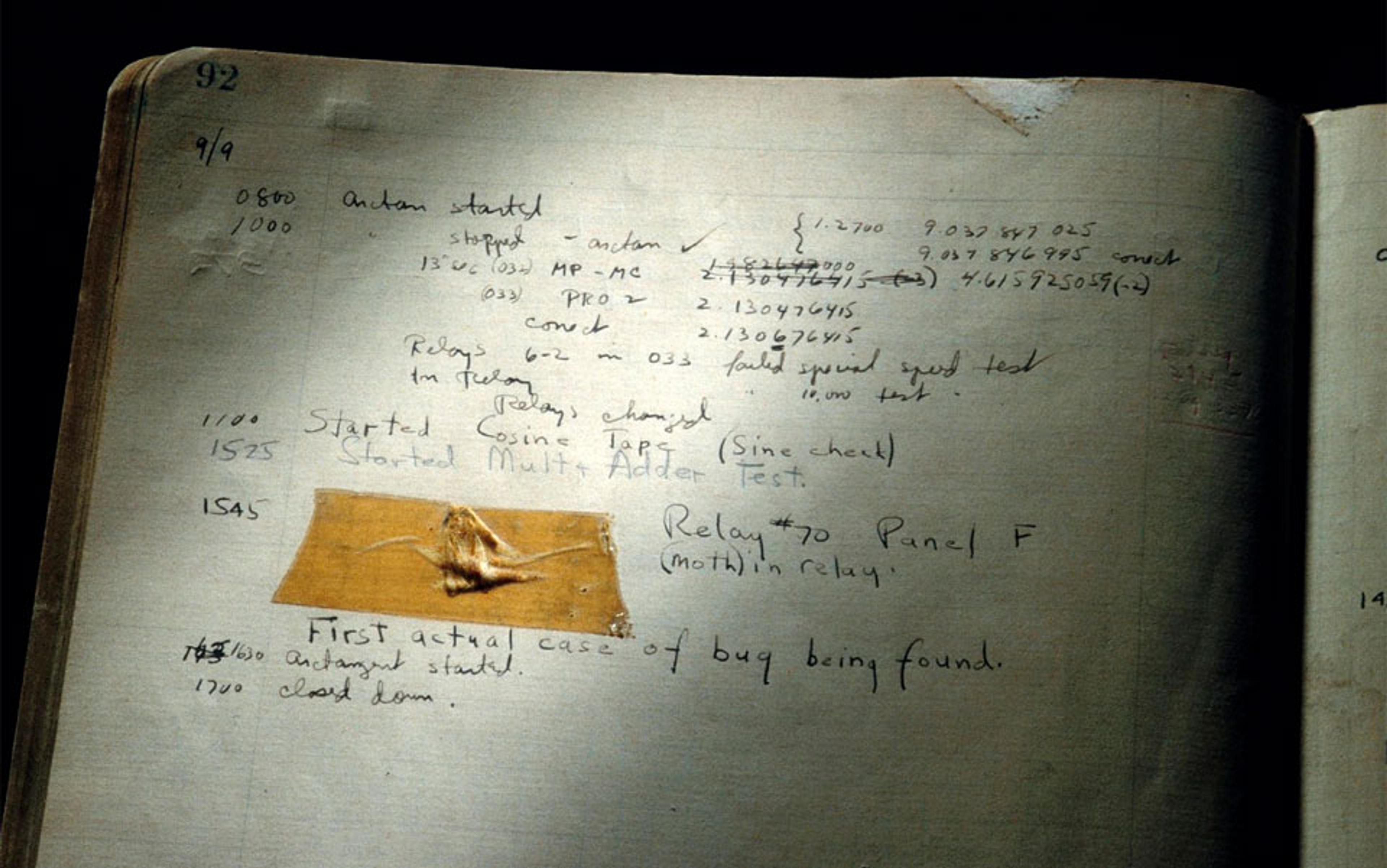 An old handwritten logbook with a taped moth, noting the first case of a computer bug. Handwriting and numbers are visible.