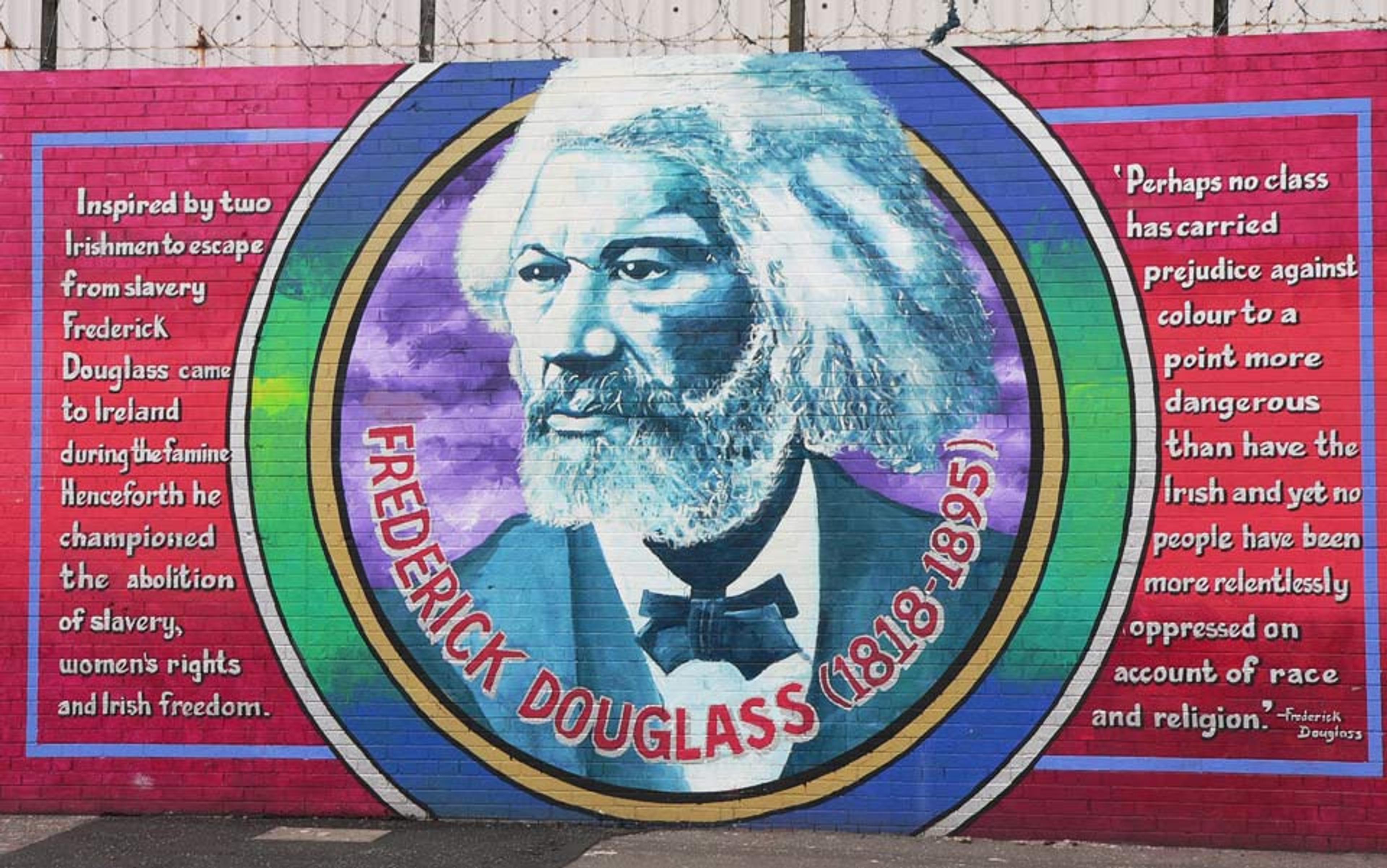 Painting of Frederick Douglass on a wall with text about his support for slavery abolition, women’s rights, and Irish freedom.