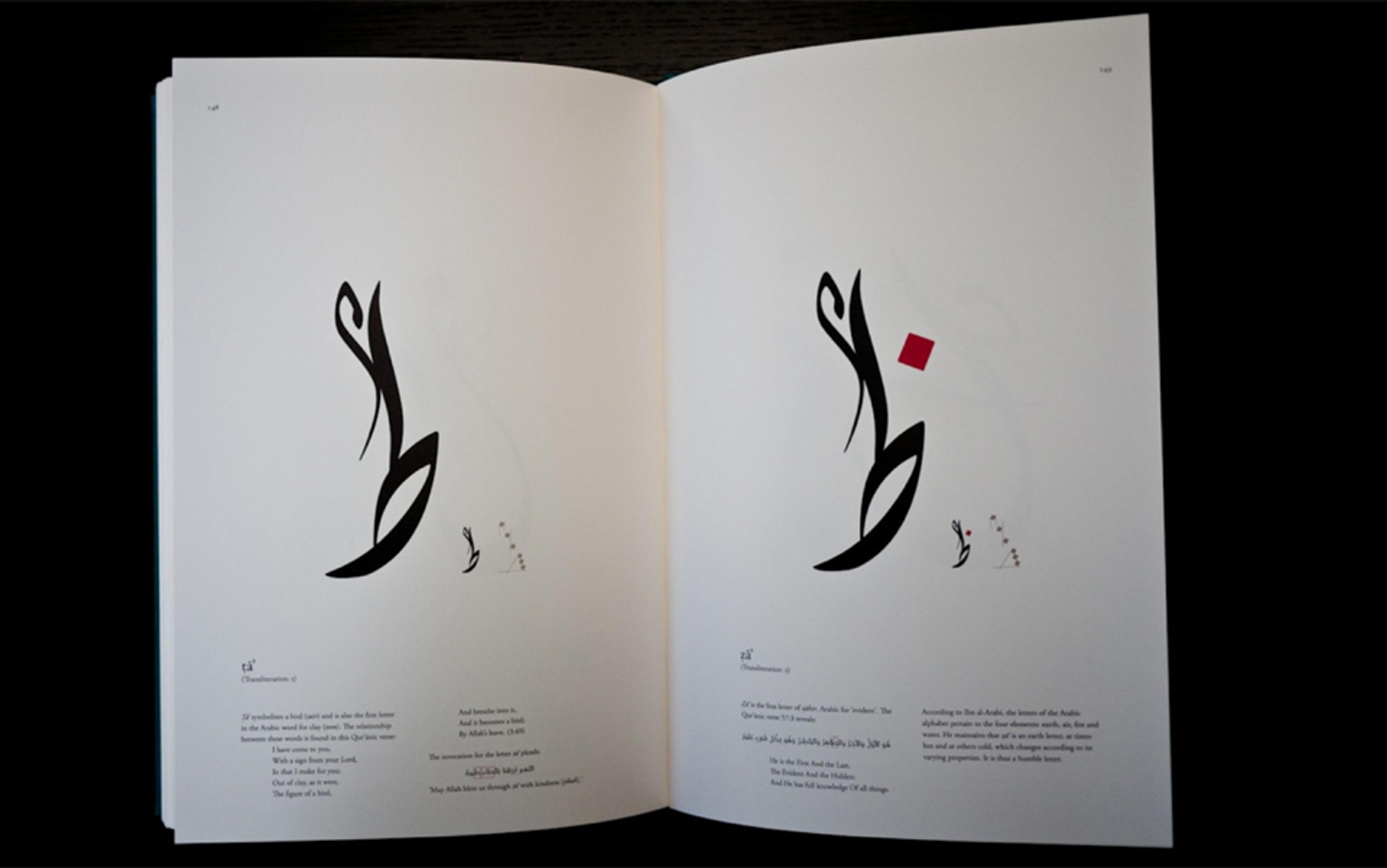 Open book with Arabic calligraphy and text, featuring black, red, and white designs on both pages.