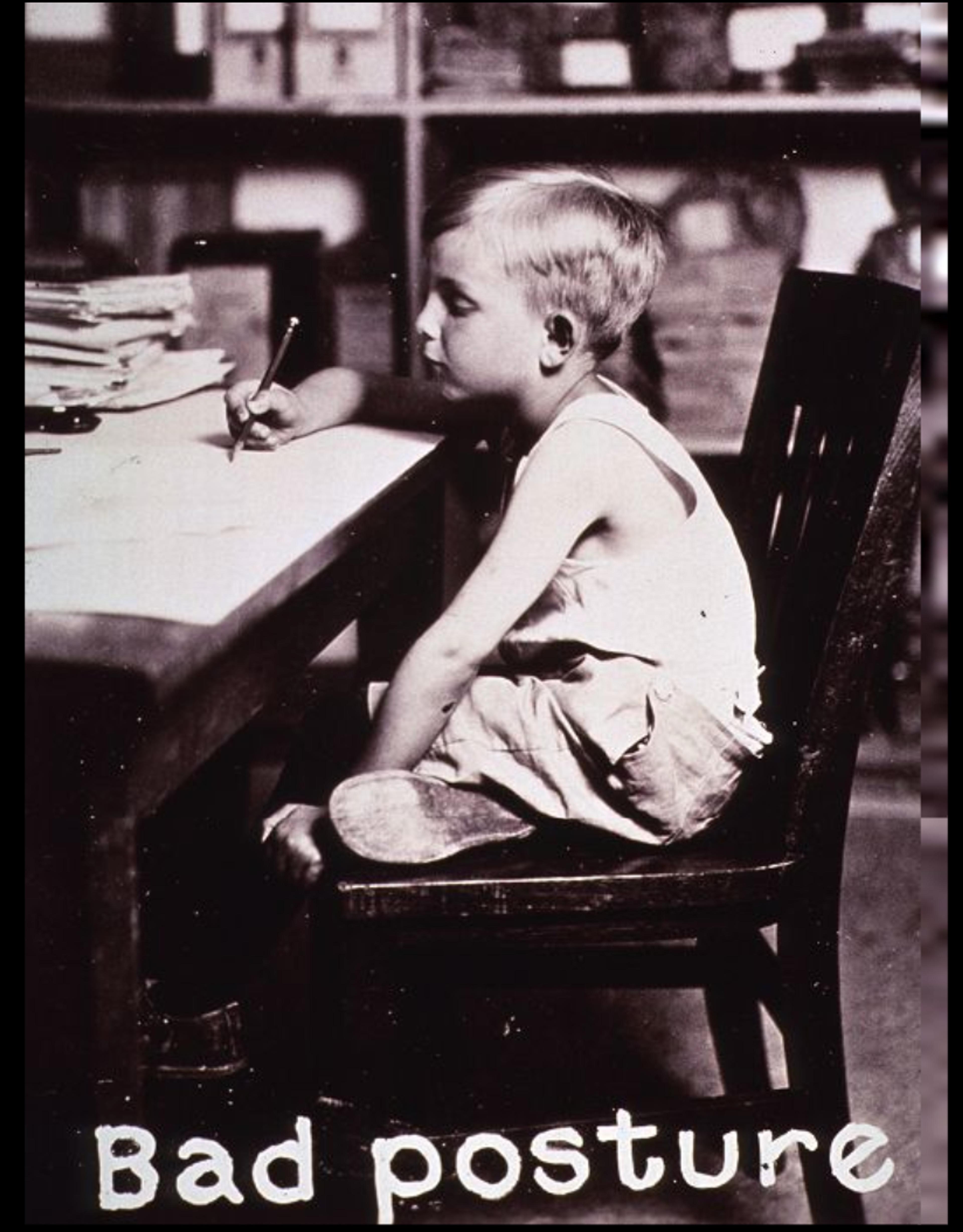 Vintage photo of a child sitting at a desk with a curved back, holding a pencil, captioned “Bad posture” at the bottom.