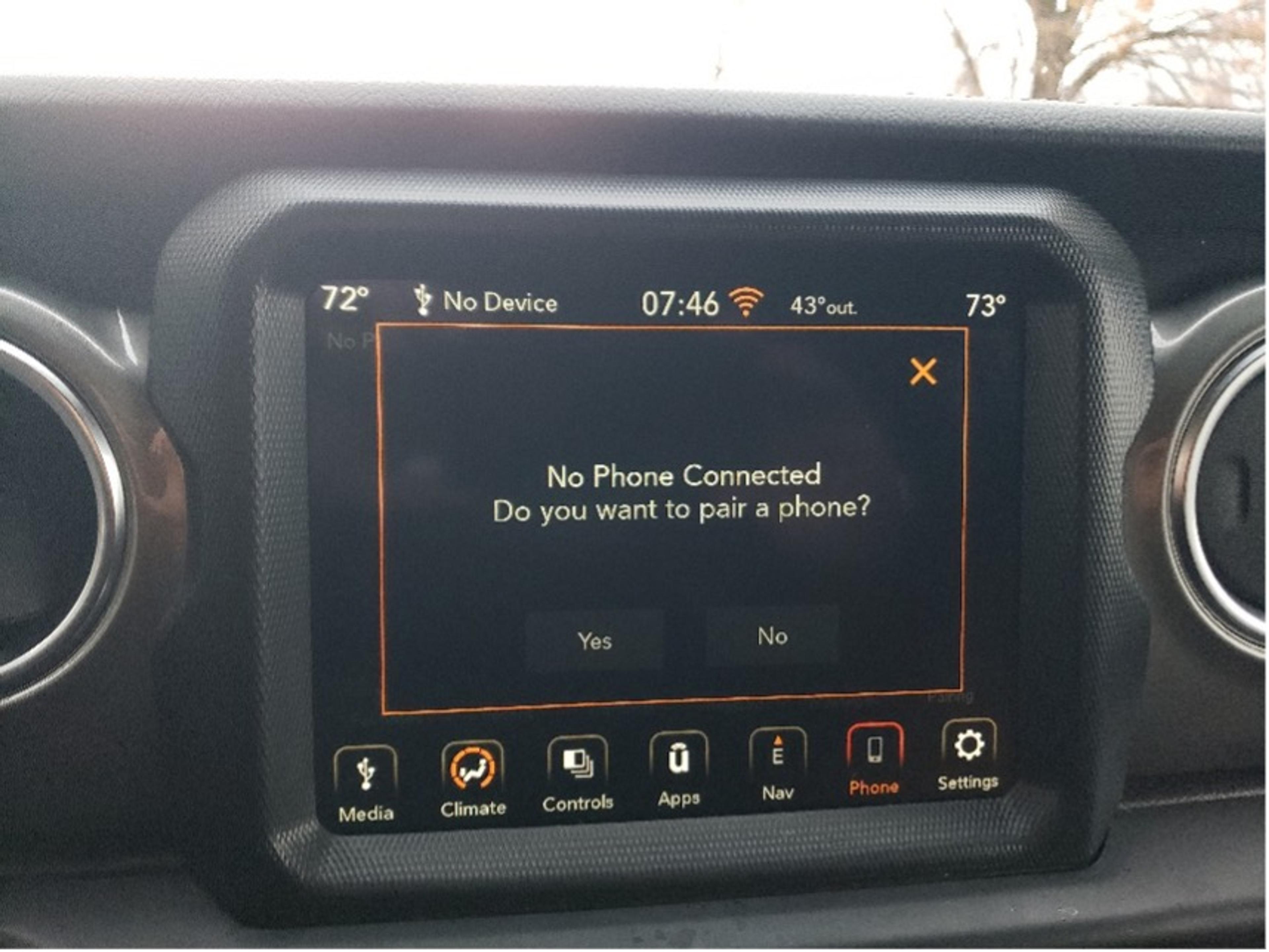 Photo of a car infotainment screen prompting to pair a phone; options to select ‘Yes’ or ‘No’ are visible.