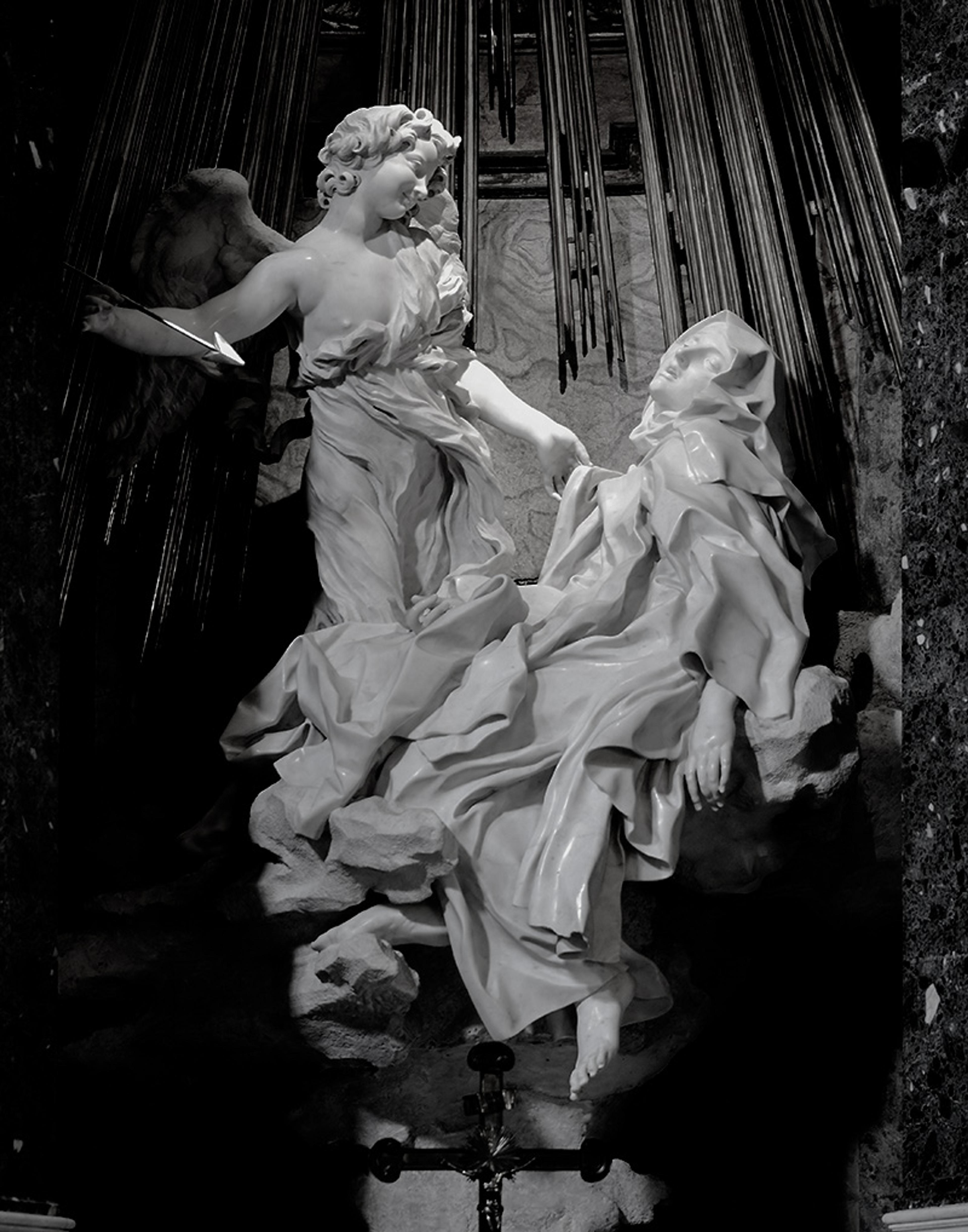 Baroque marble sculpture of an angel holding an arrow near a reclining figure with drapery, in a dramatic light setting.