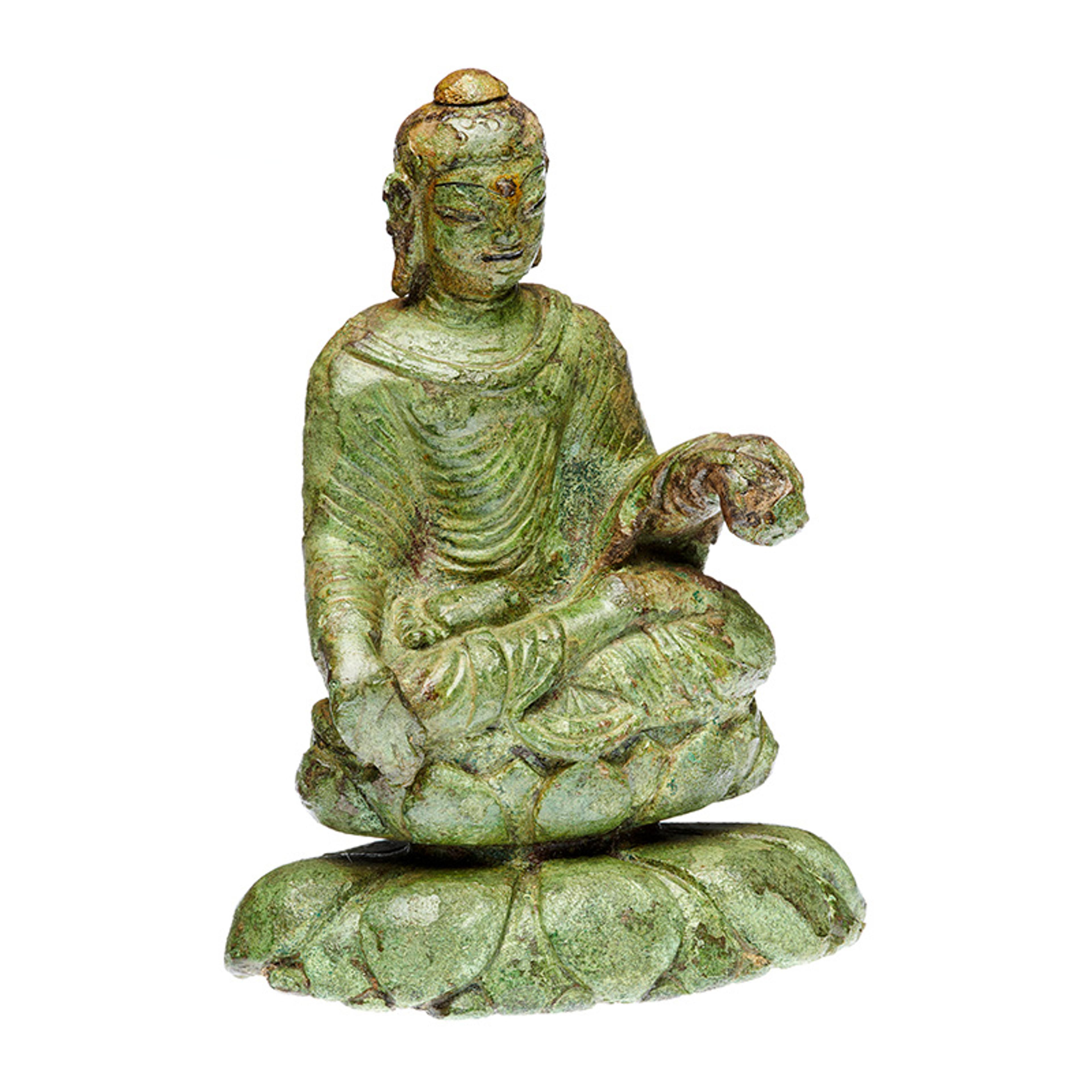 Green stone sculpture of a seated Buddha on a lotus base with detailed robes, holding an object.