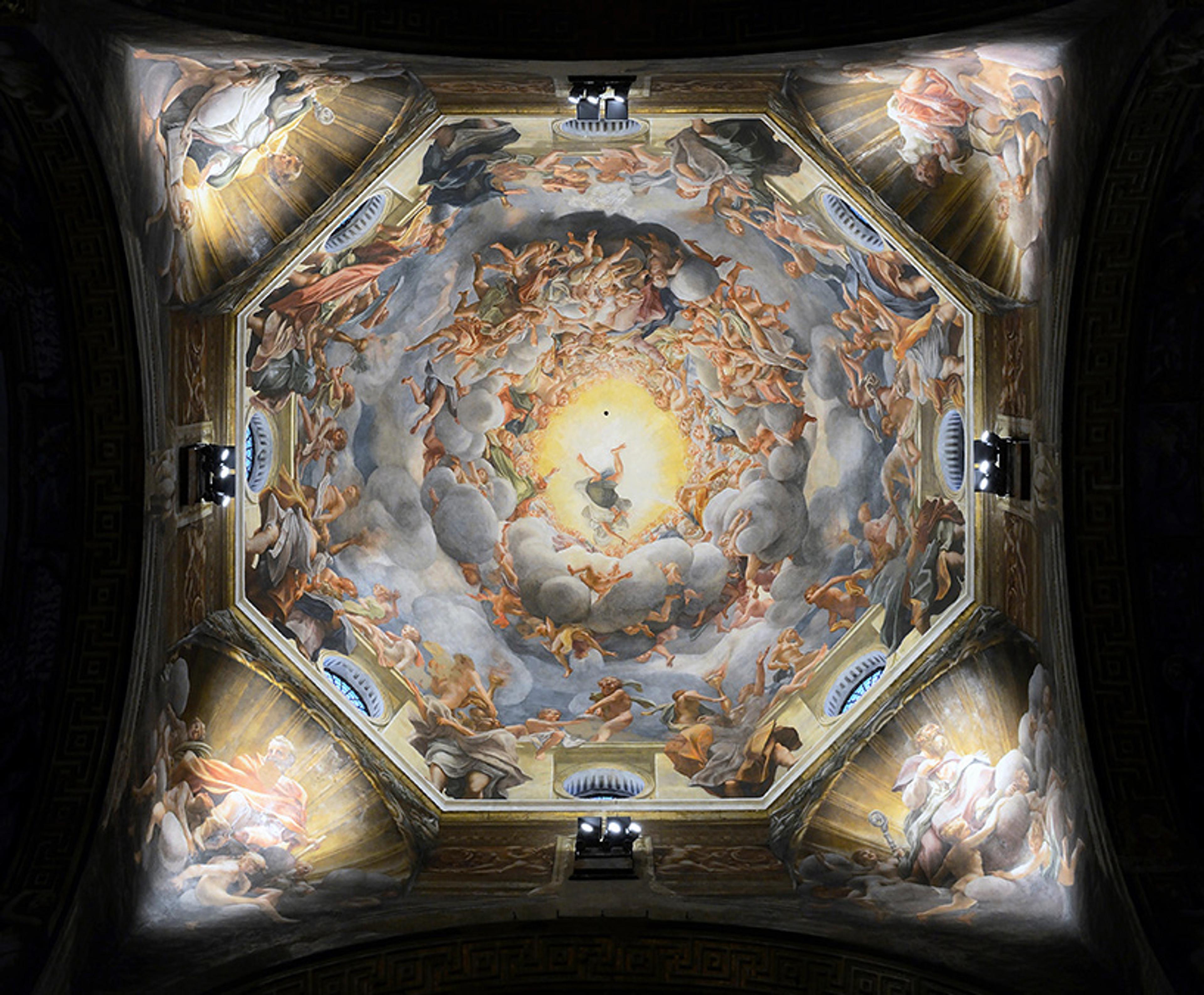 Ceiling painting depicting an intricate scene of angels and figures amidst clouds with a bright centre, in a dome perspective.