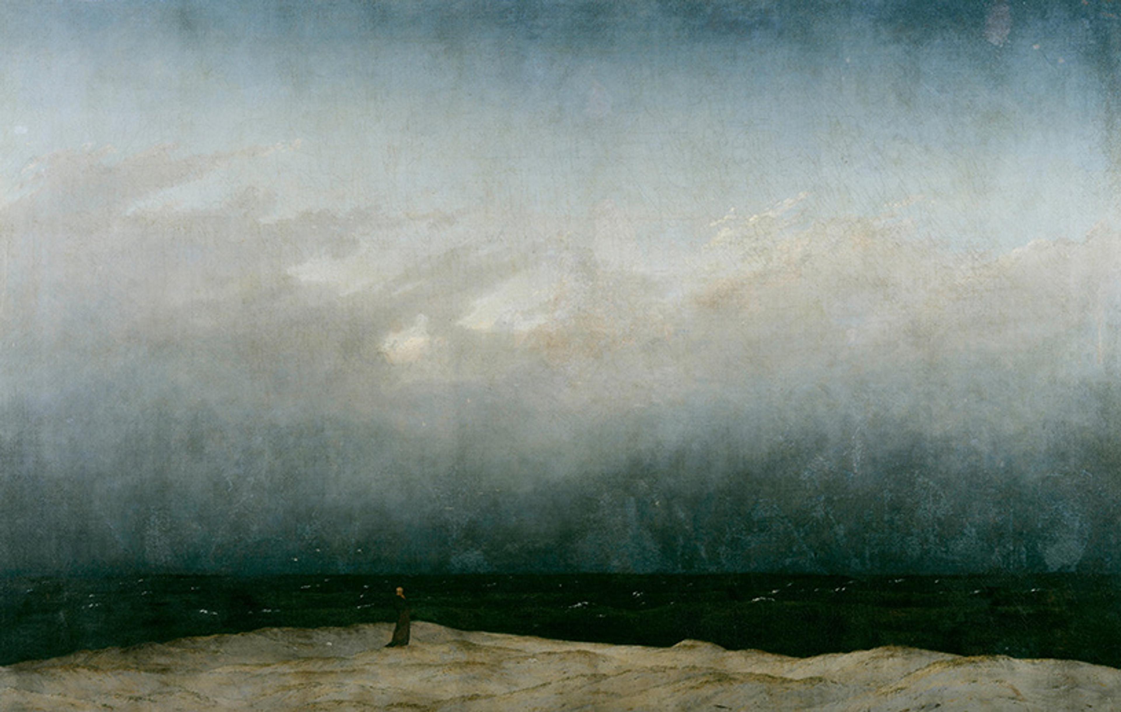 Painting of a solitary figure on a sandy shore under a vast cloudy sky facing a dark sea.