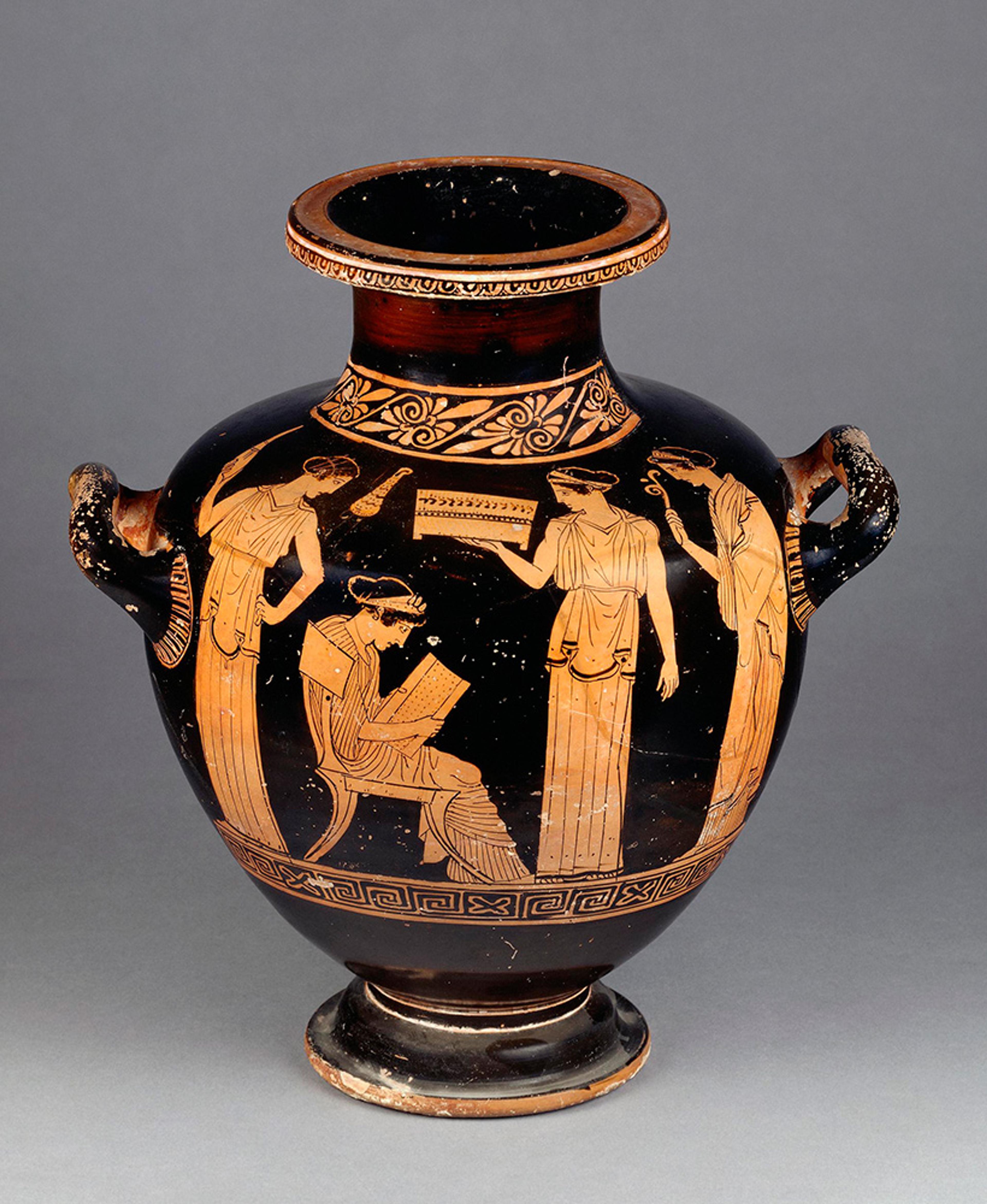 Ancient Greek pottery shows a seated figure reading and four standing figures, decorative red-figure design on a black vase.