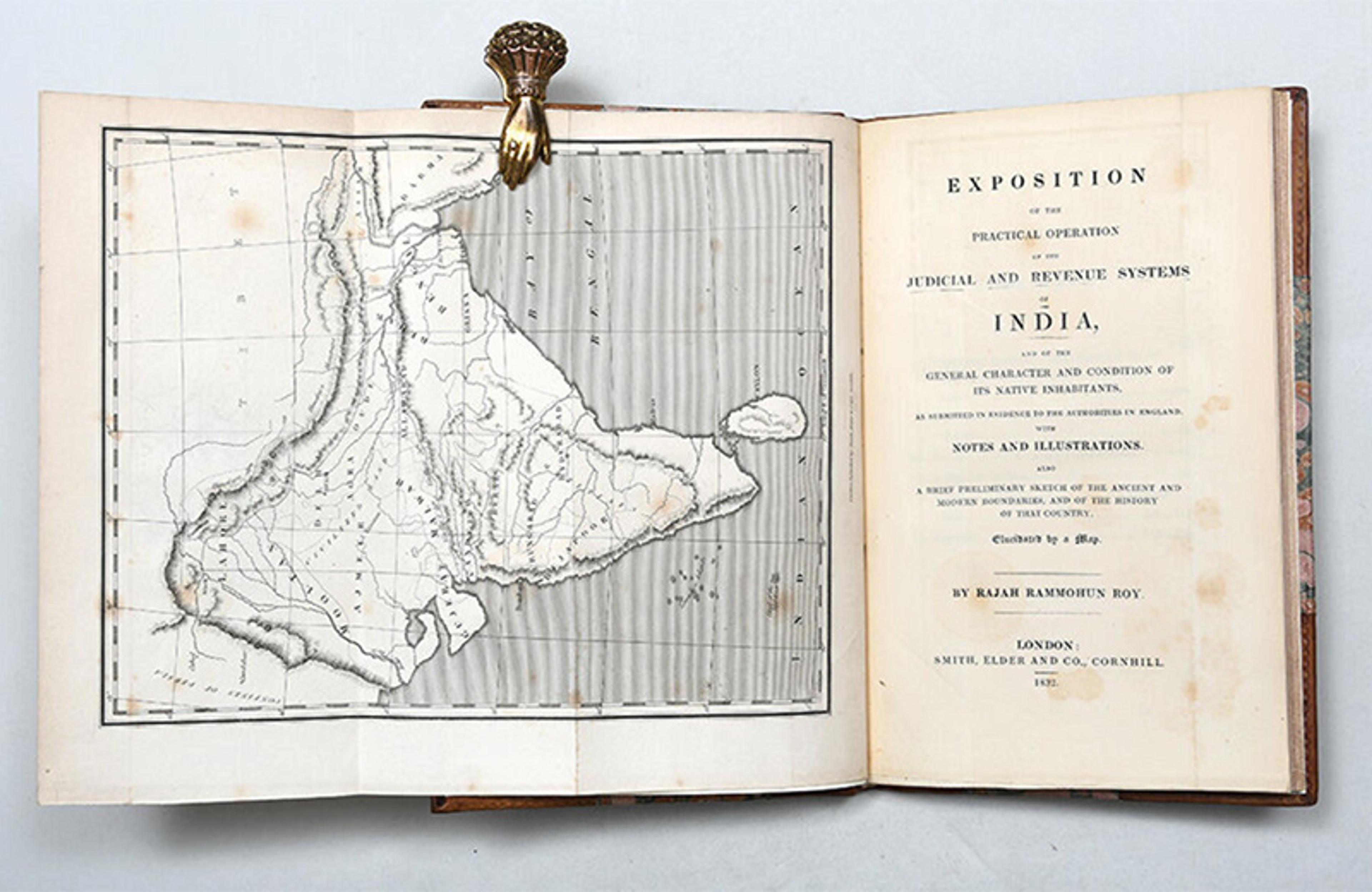 Old book about India’s judicial systems with a map, metal clip holds pages open; published in 1832.