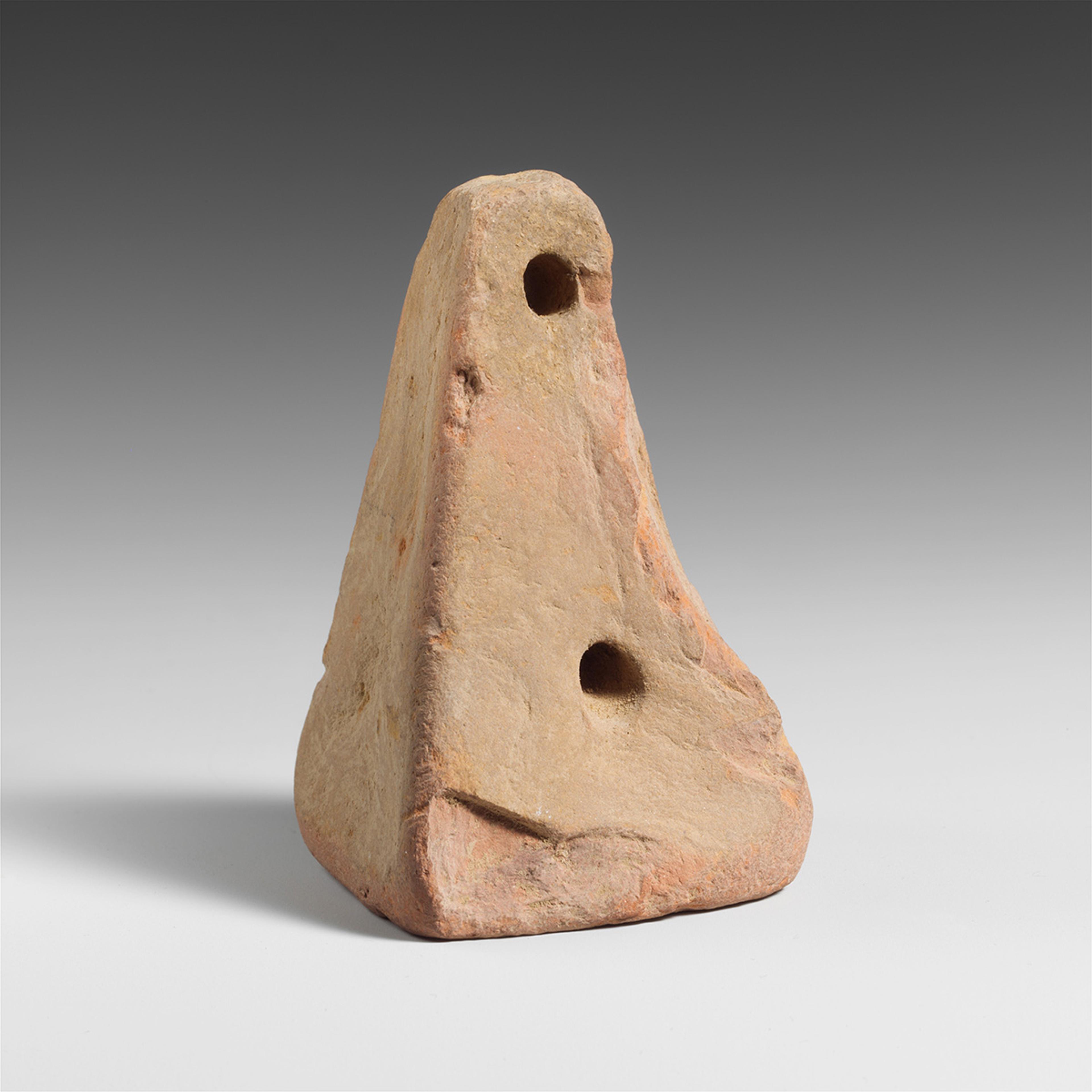 Triangular stone weight with two holes displayed on a grey gradient background.