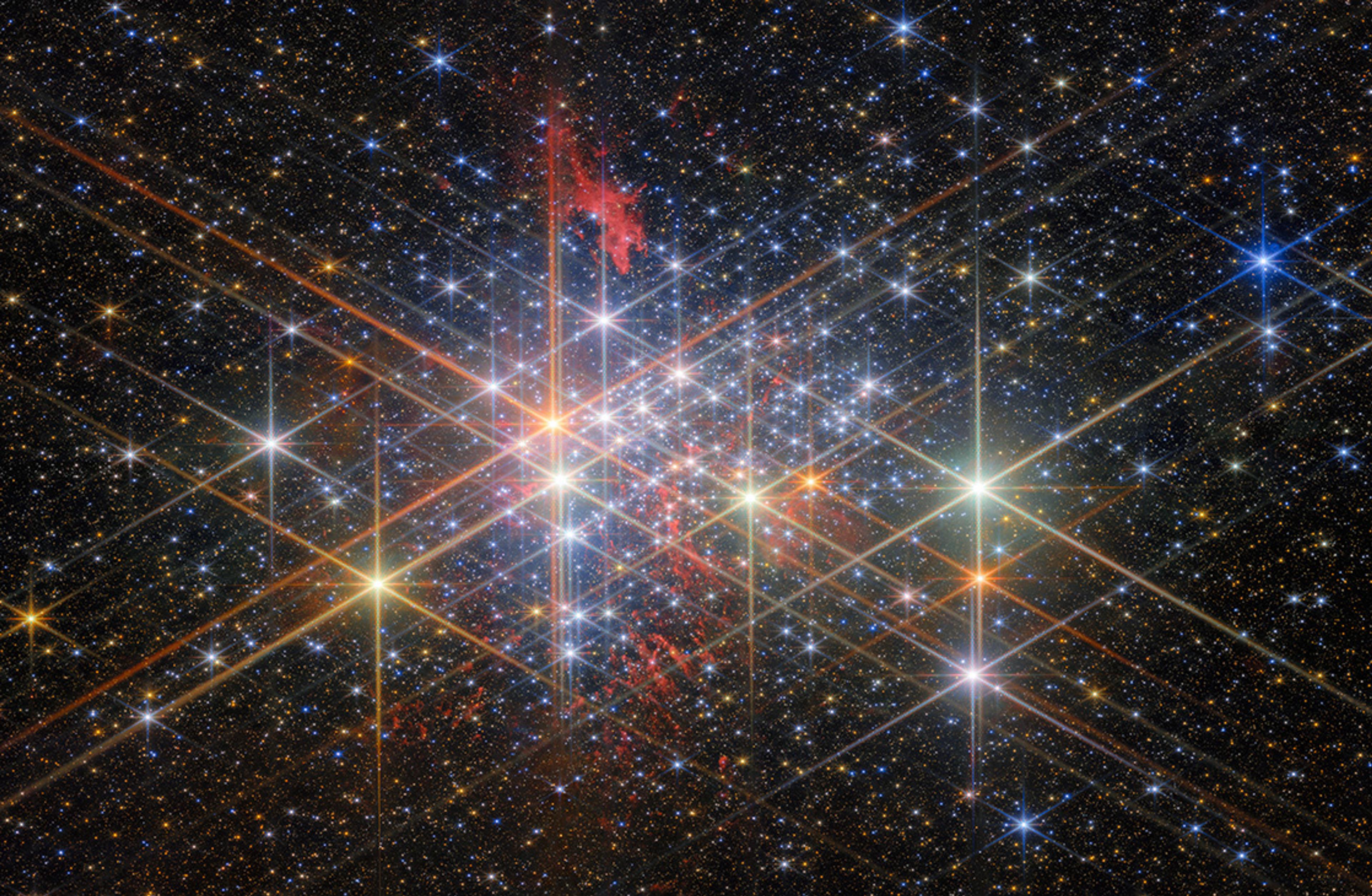 A colourful star cluster in space with bright stars and nebulae, displaying diffraction spikes and cosmic dust.