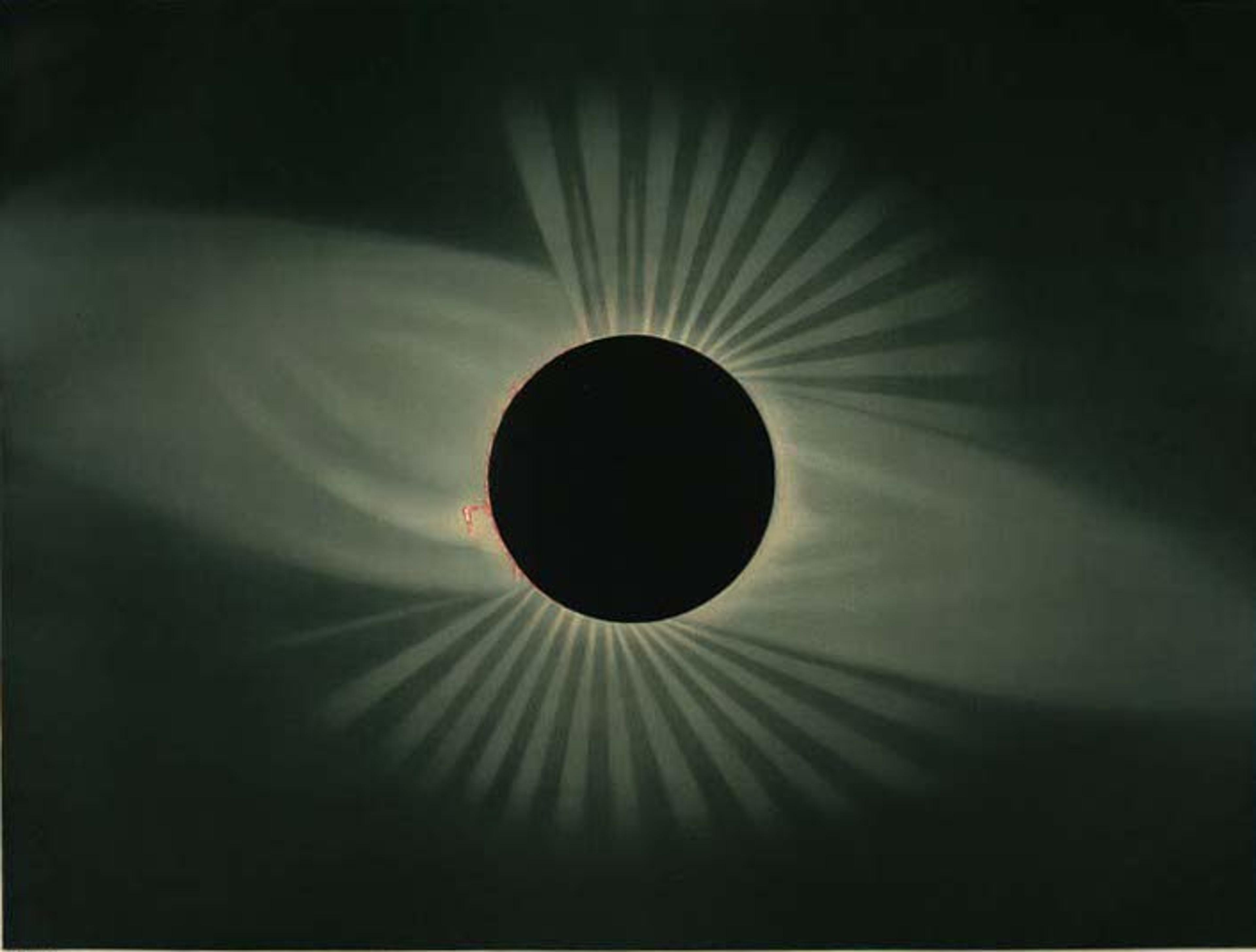Image of a solar eclipse showing the sun’s corona as rays around the darkened moon.